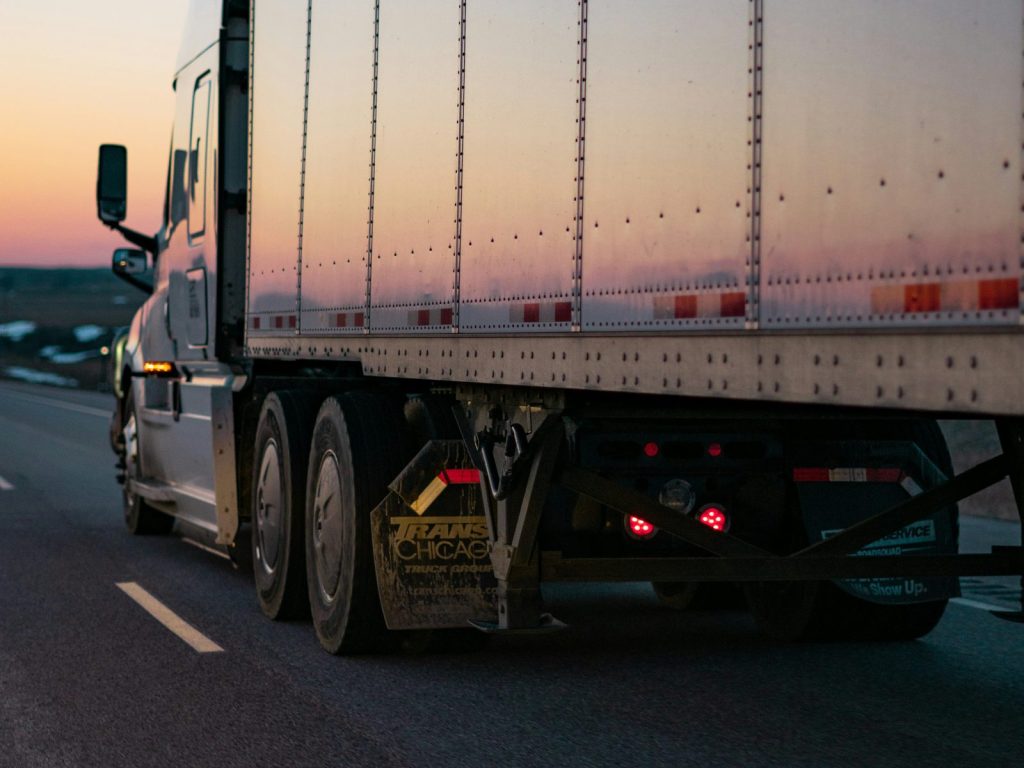 Semi truck on the highway at sunset